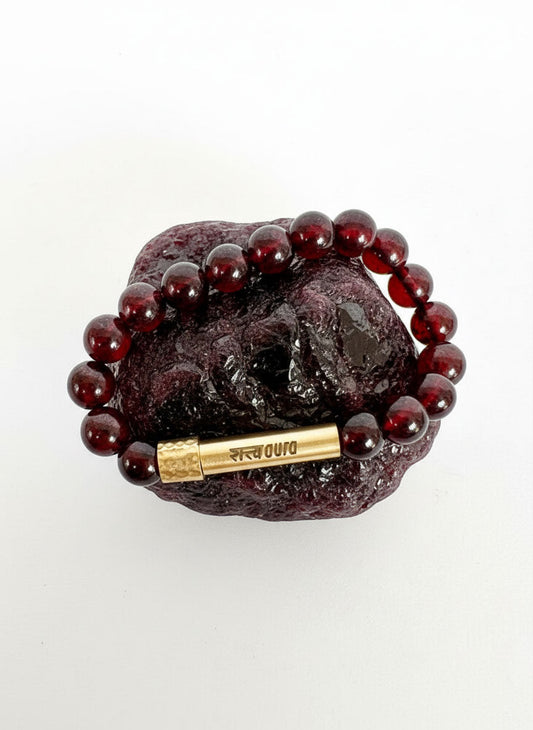 Garnet stone bracelet worn on wrist
