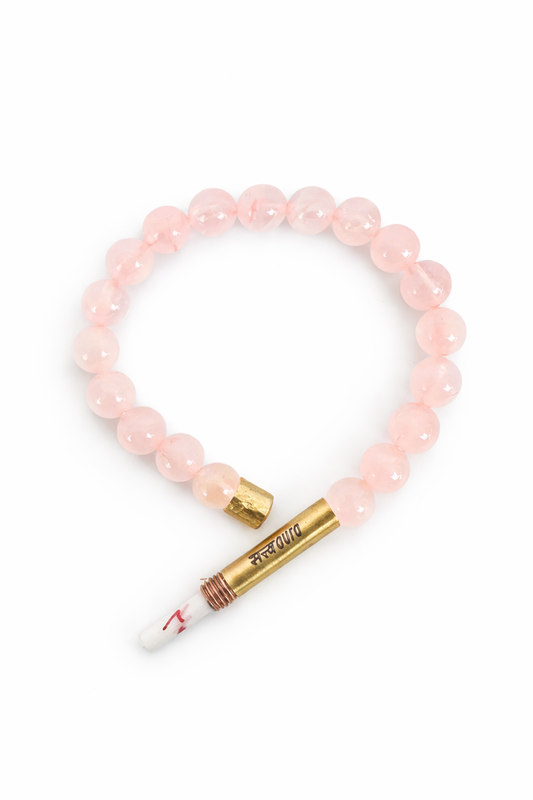 Rose quartz stone bracelet worn on wrist