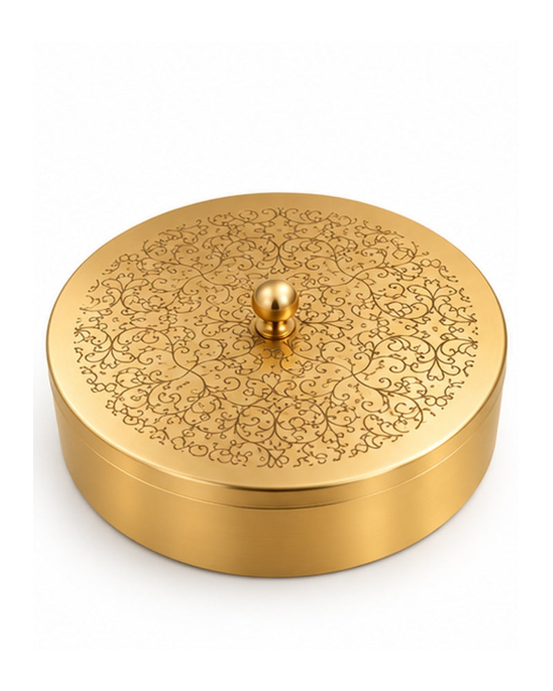 Engraved brass masala dabba with lid closed, white background