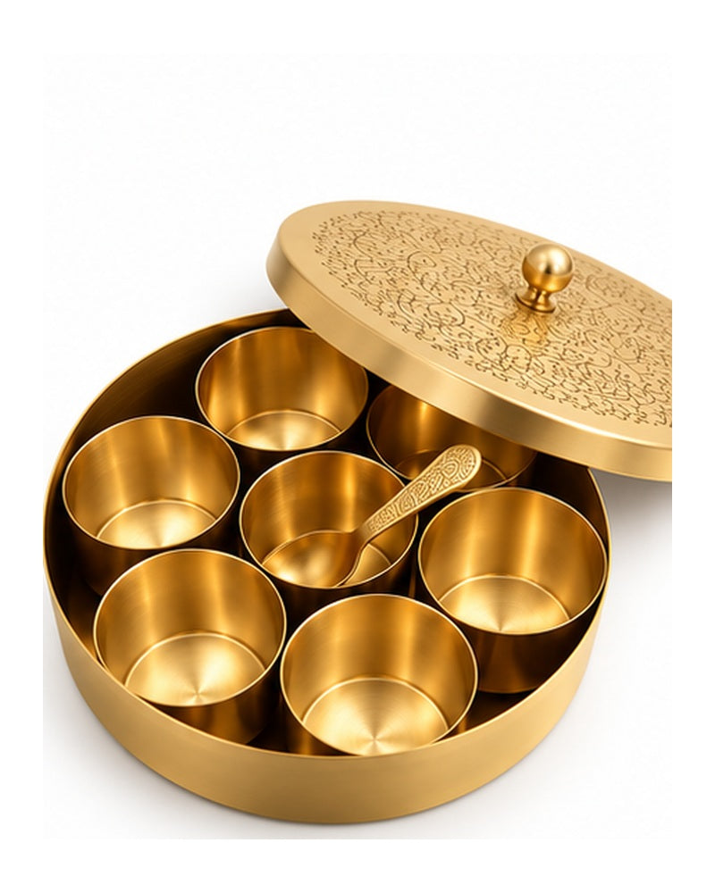 Brass masala dabba with engraved lid tilted open