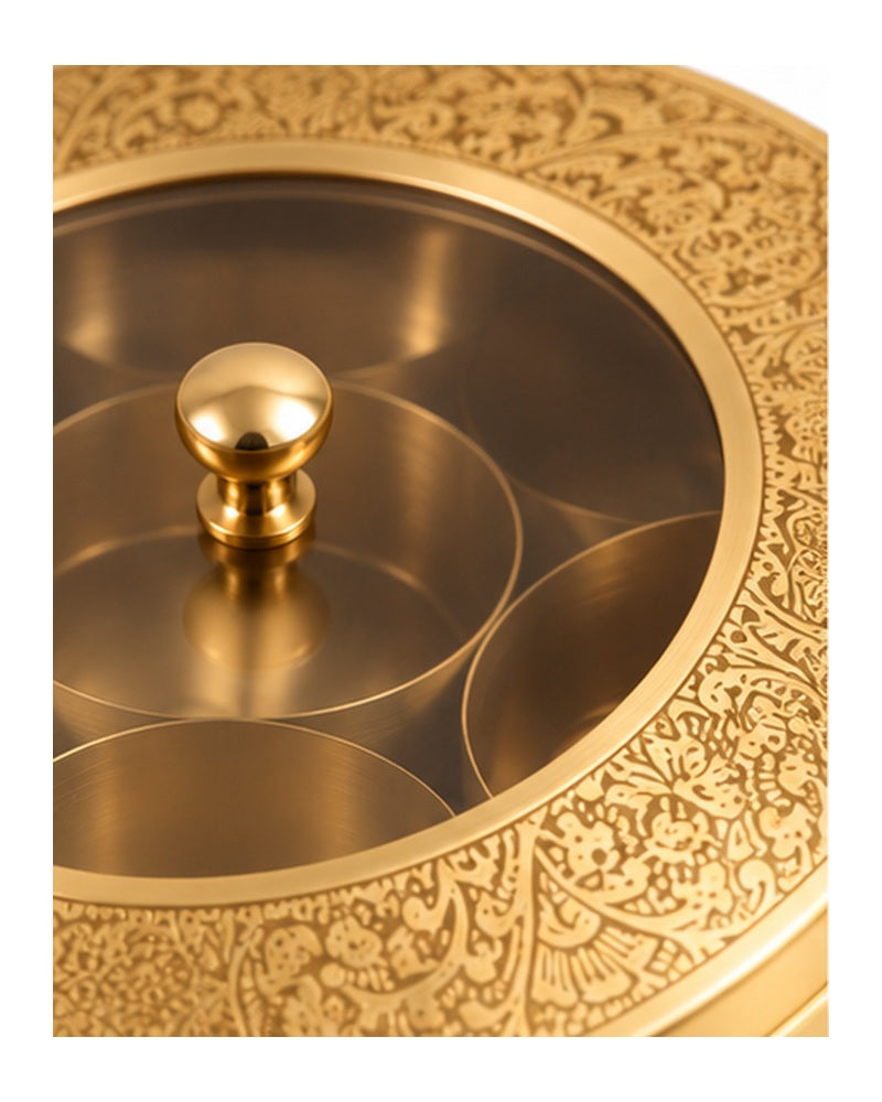 Close-up of the engraved brass rim and knob on the clear lid