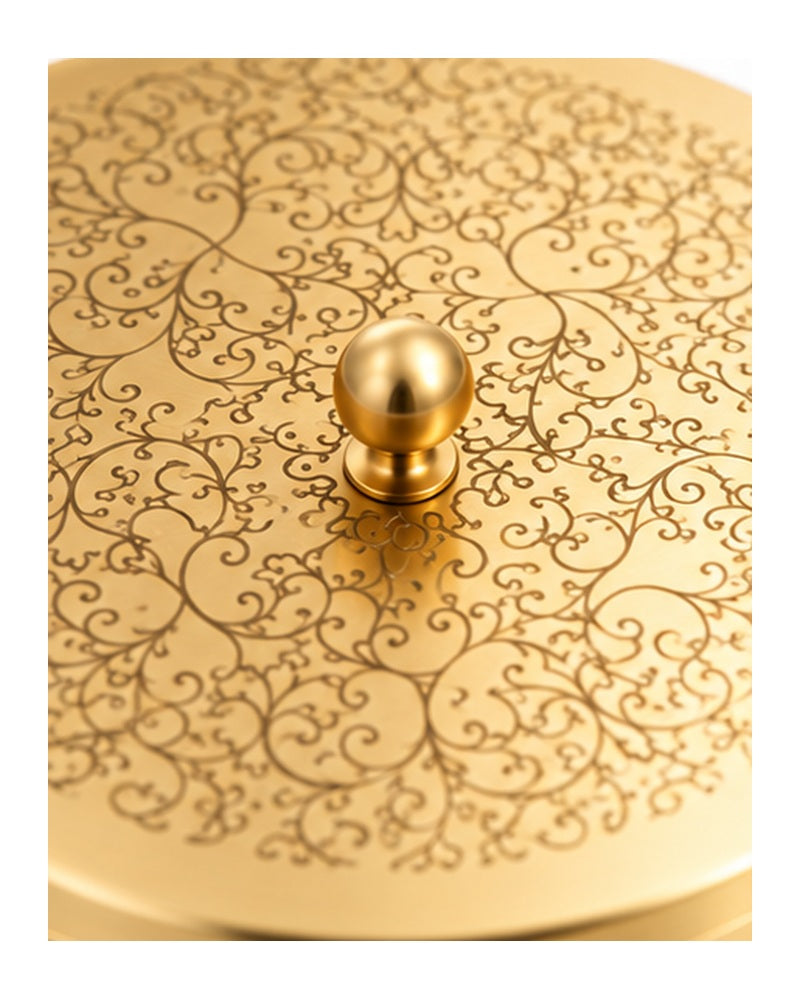 Close-up of the floral engraving and knob on the brass dabba lid