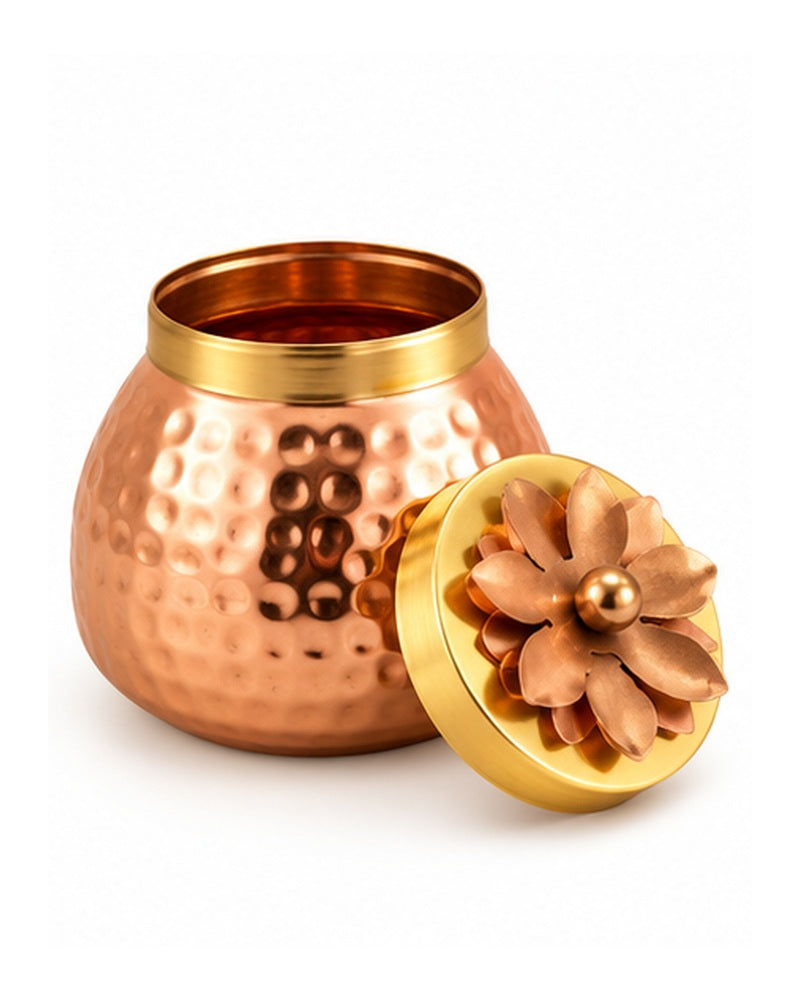 Close-up of a copper-tone hammered jar with petal lid