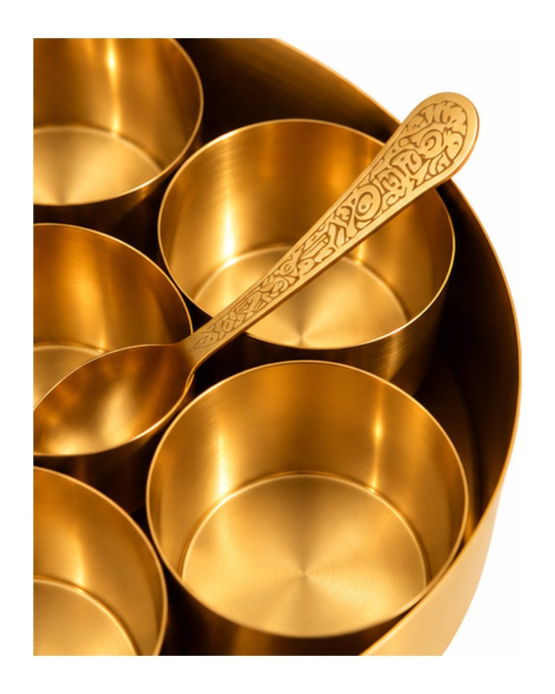 Close-up of brass spice bowls and spoon