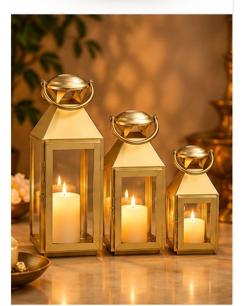 Gold candle lanterns set of 3, lit, in a festive setting