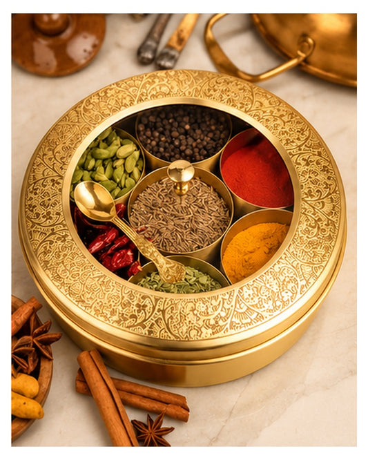 Brass masala dabba with clear lid filled with colourful spices