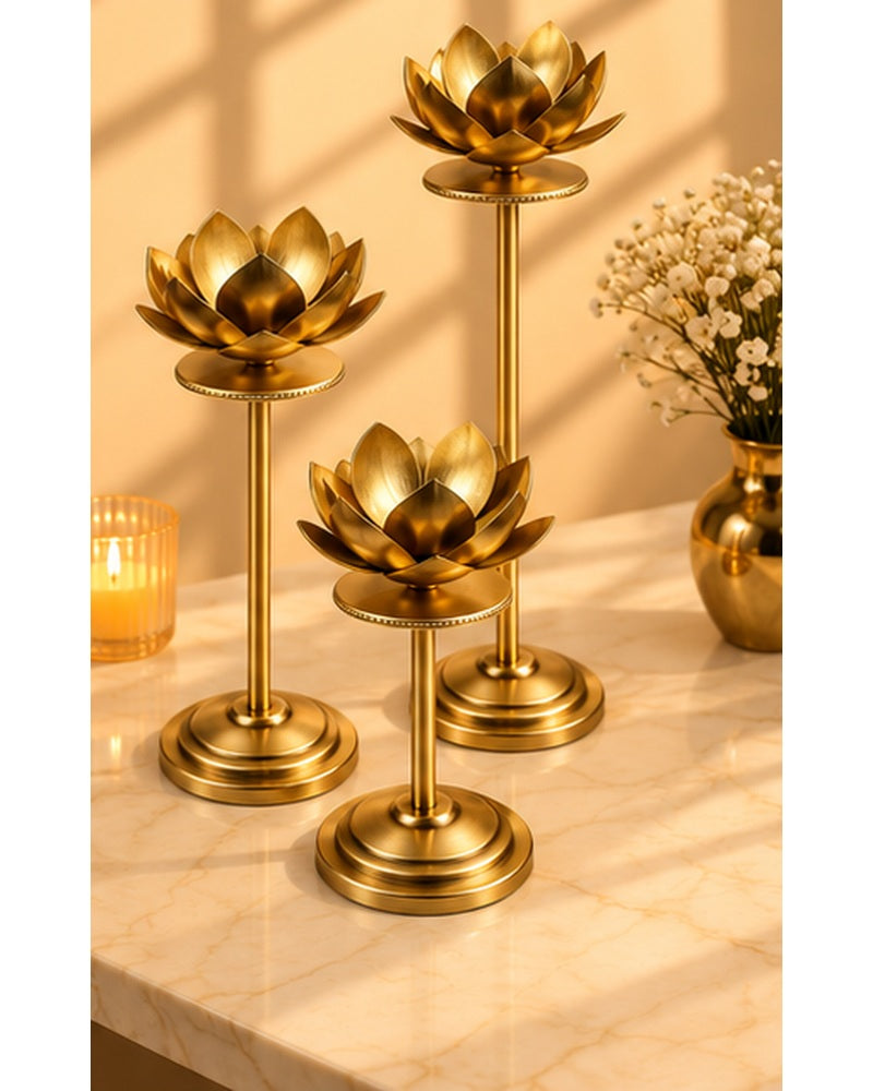 Gold lotus candle stands set of 3, styled in a warm festive setting