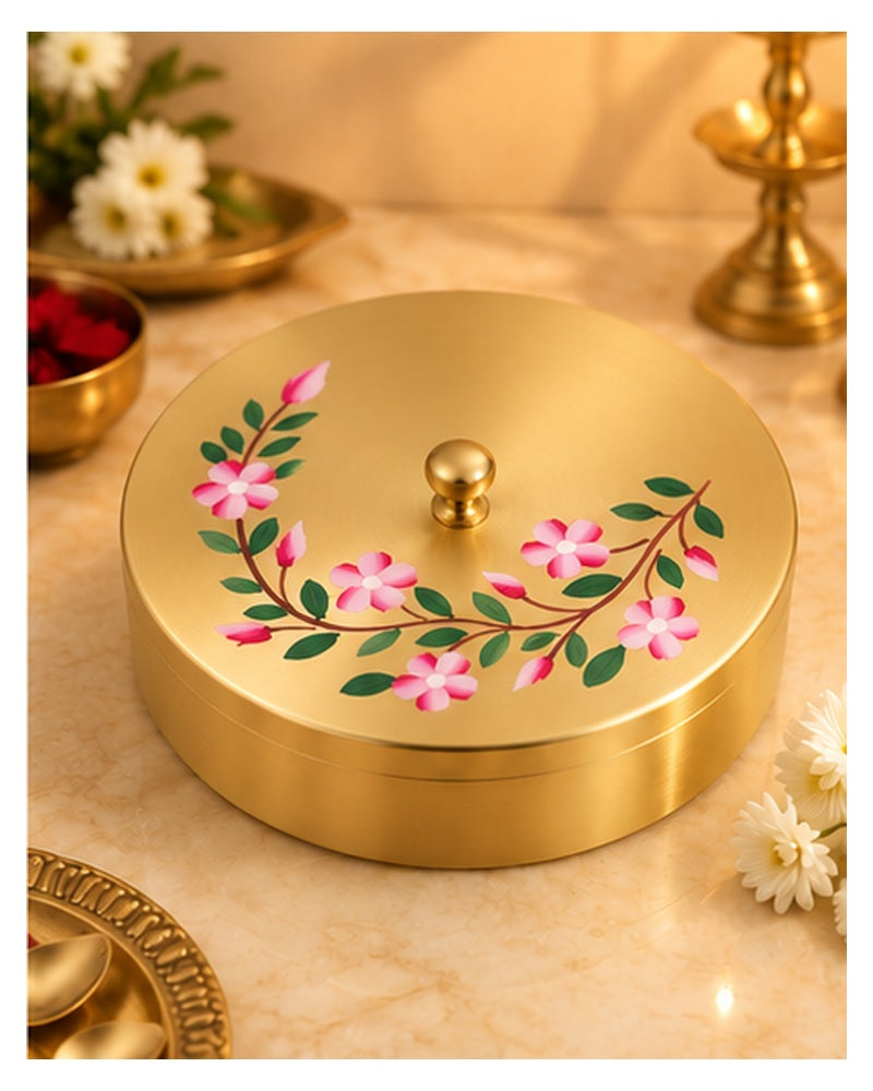 Floral painted brass spice box on a marble counter