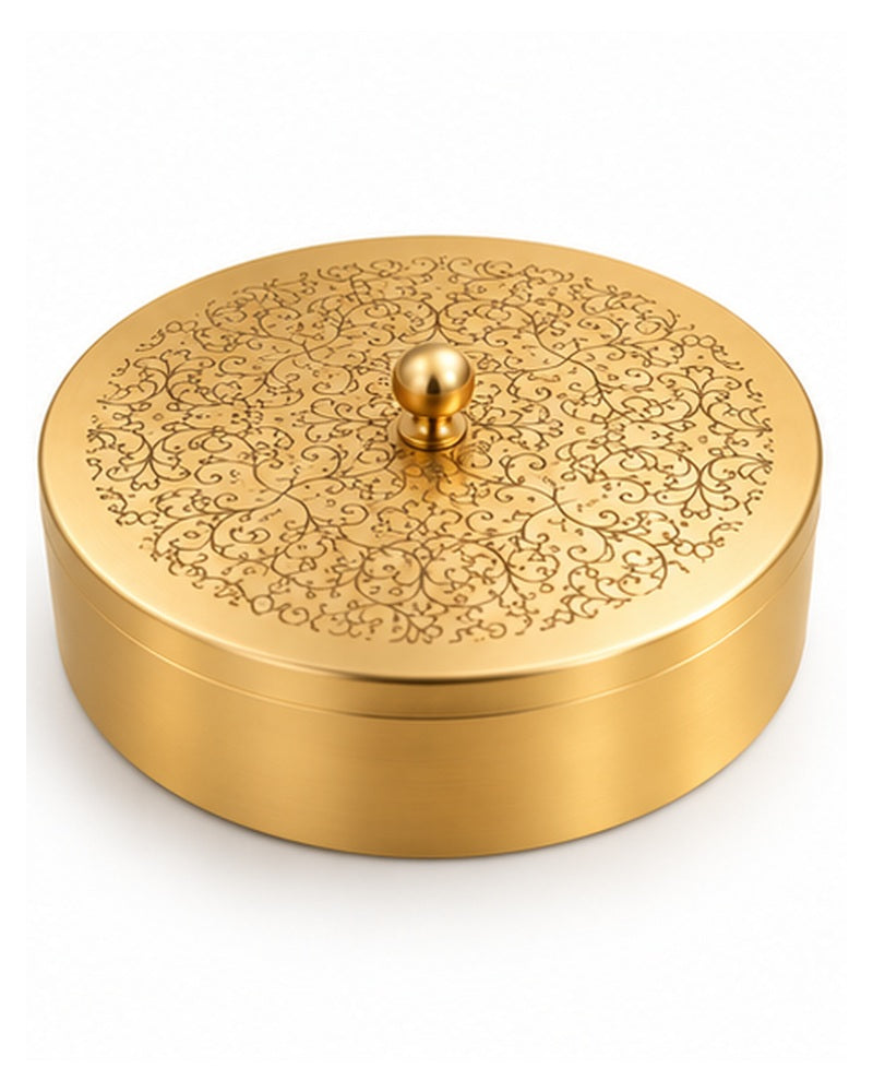 Engraved brass spice box styled in a warm kitchen setting