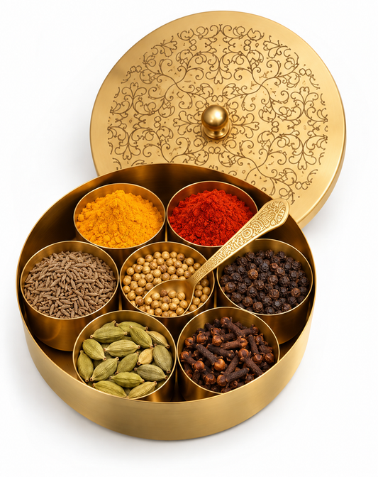 Engraved brass masala dabba open with seven bowls of spices and a spoon