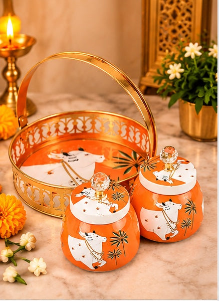 Orange Pichwai cow basket tray with 2 jars, styled in a festive setting