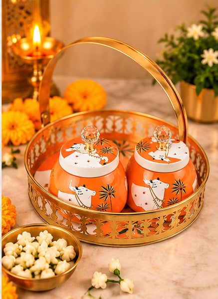 Orange Pichwai cow basket tray with 2 jars, styled view