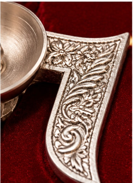 Silver swastik diya in red velvet box
